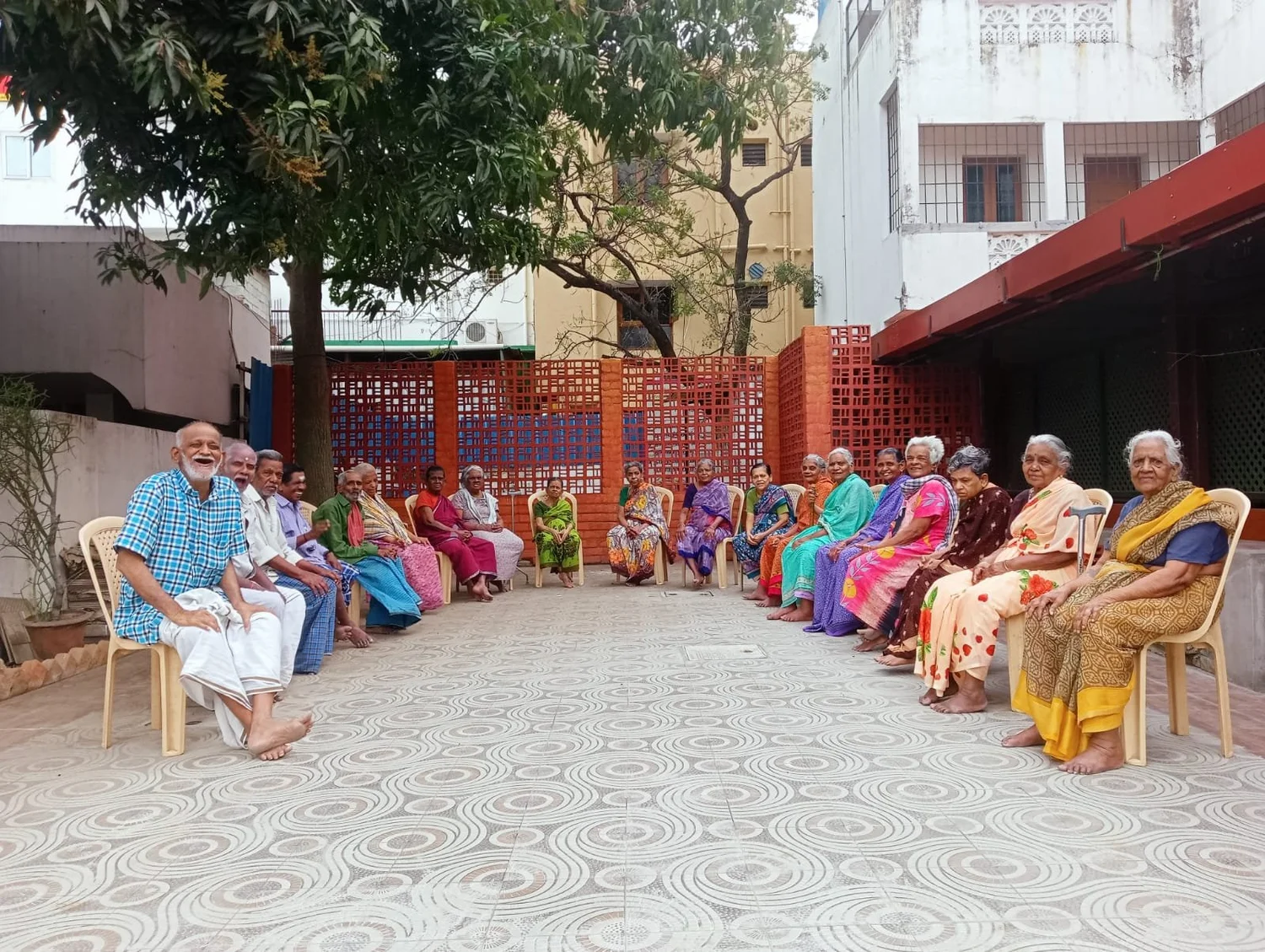 Older adults spending time together in an Indian community courtyard — illustrative photograph
